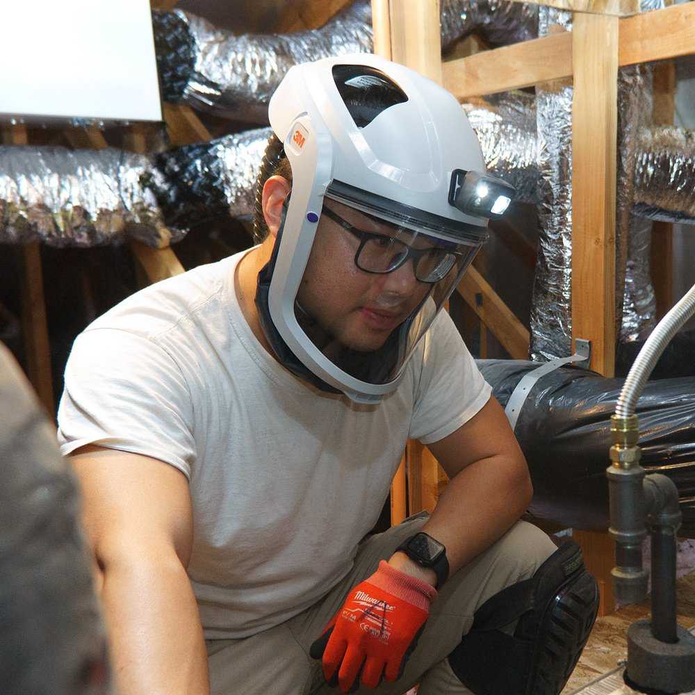 Austin Liu working on HVAC ductwork